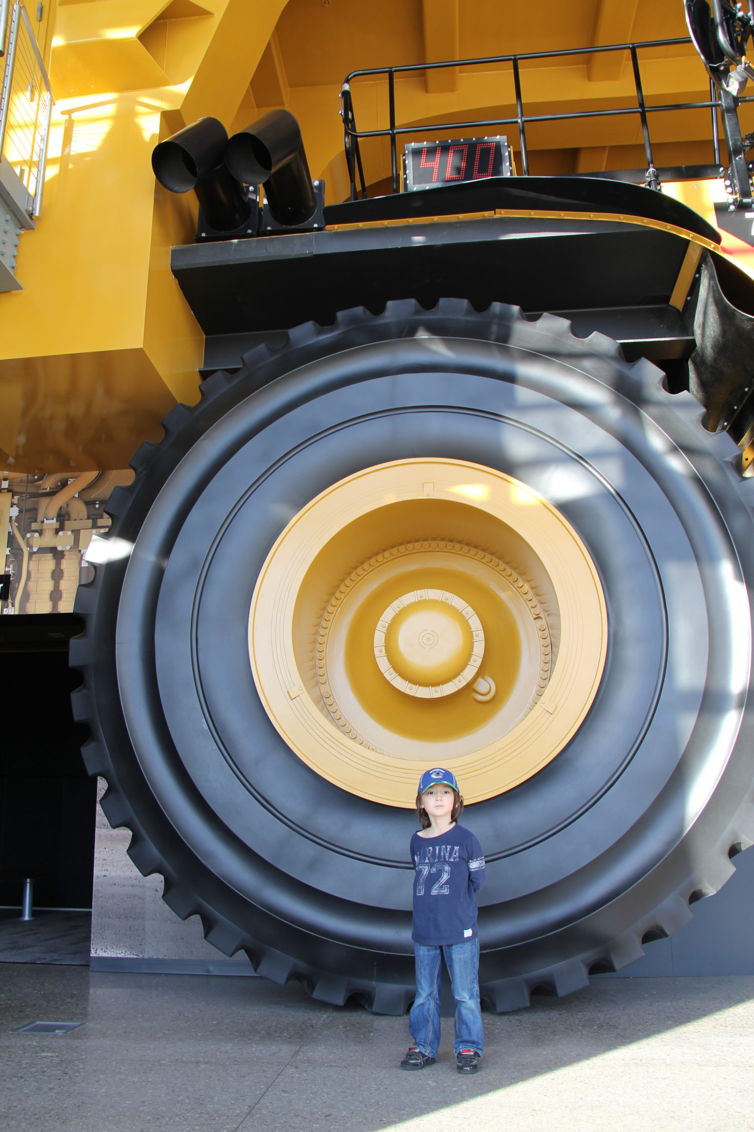 Seiji in front of a giant mining truck at the Caterpillar Visitor Centre in Peoria, Illinois.