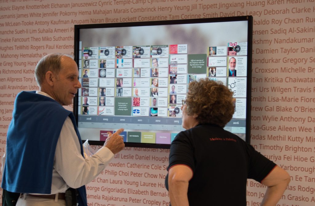 A conference attendee looking at Timeline with RCPA Executive Officer Debbie Deston.